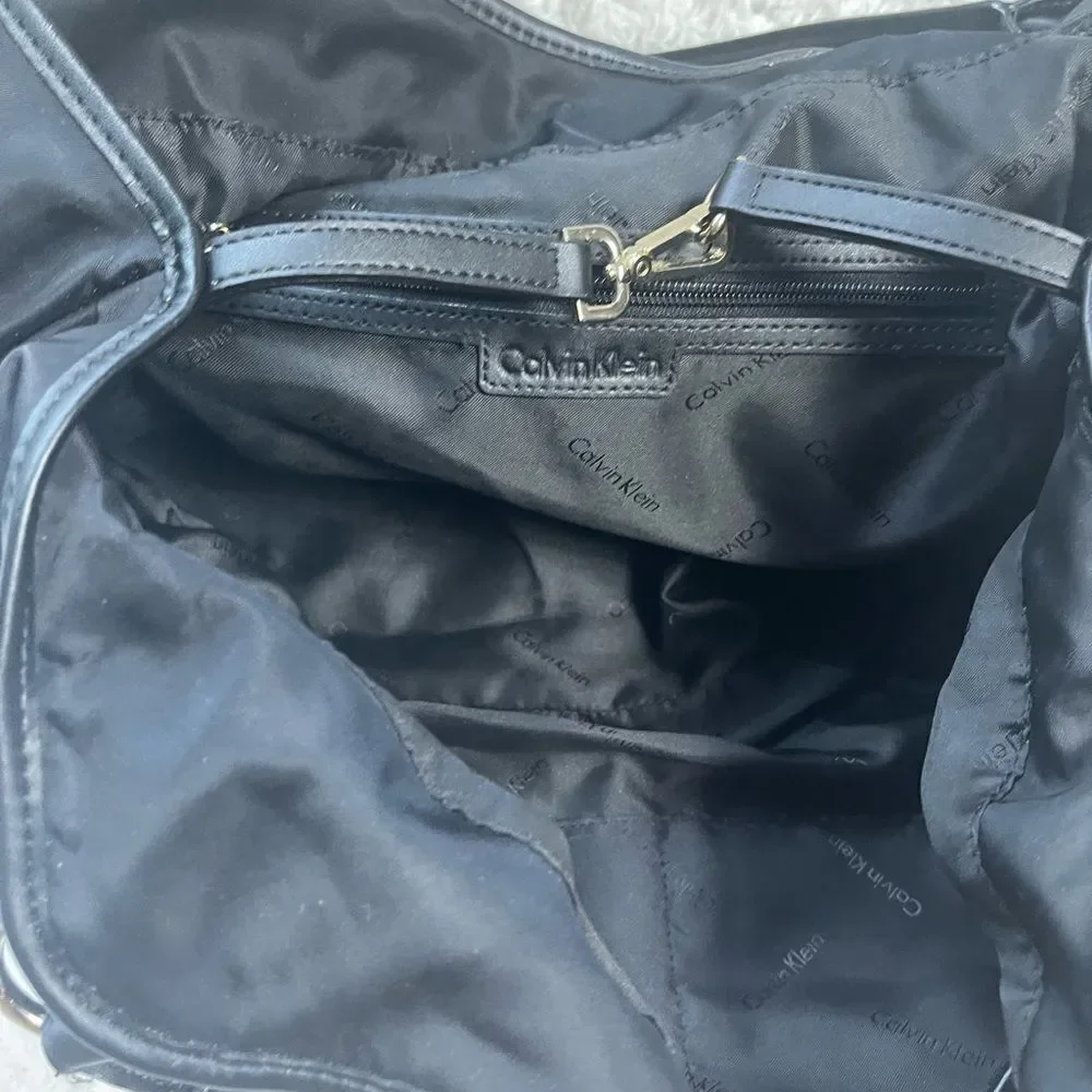 Calvin Klein Black Nylon large shoulder bag with gold tone hardwares.